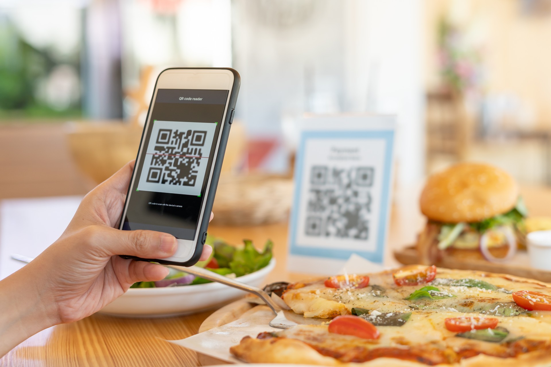 Woman use smartphone to scan QR code to pay in cafe restaurant with a digital payment without cash. Choose menu and order accumulate discount. E wallet, technology, pay online, credit card, bank app.